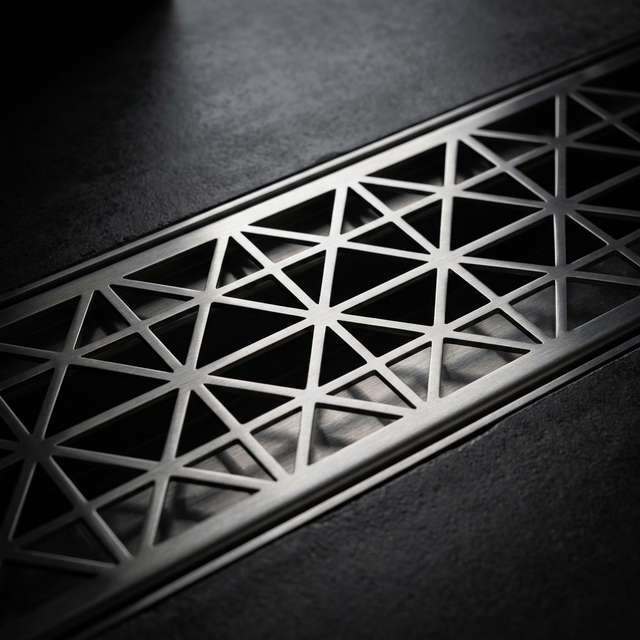 Precision-cut stainless steel floor grating with geometric pattern